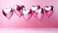 Foil air balloons on pastel pink background. Pink heart shaped helium balloons on pink background. Minimal love concept. Valentine