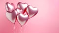 Foil air balloons on pastel pink background. Pink heart shaped helium balloons on pink background. Minimal love concept. Valentine