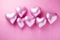 Foil air balloons on pastel pink background. Pink heart shaped helium balloons on pink background. Minimal love concept. Valentine