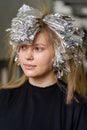 Foil on models hair. Trendy hair lightening using shatush technique. Royalty Free Stock Photo