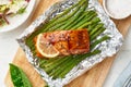 Foil pack dinner with red fish. Fillet of salmon with asparagus. Oven-baked hot dinner, keto paleo diet