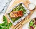 Foil pack dinner with red fish. Fillet of salmon with asparagus. Oven-baked hot dinner, keto paleo diet