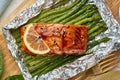 Foil pack dinner with red fish. Fillet of salmon with asparagus. Oven-baked hot dinner, keto paleo diet Royalty Free Stock Photo