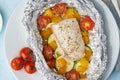 Foil pack dinner with white fish. Oven baked fillet of cod, pike perch with vegetables Royalty Free Stock Photo