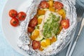 Foil pack dinner with white fish. Oven baked fillet of cod, pike perch with vegetables Royalty Free Stock Photo