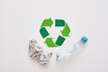 Foil and plastic. Crumple foil and plastic are lying near recycle symbol