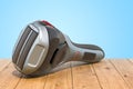 Foil-type cordless razor, shaver on the wooden planks, 3D rendering