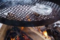 Foil wrapped food on a grill over the campfire in winter