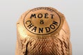 Foiled cork of Moet and Chandon champagne bottle against white background