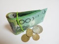 Fold of green Australian $100 dollar notes plus coin Royalty Free Stock Photo