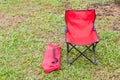 Foldable camping chair with the green lawn background.