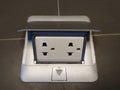 Foldable shinny metal cover with white double electric power Socket with 3 channel builted on ceramic floor, backgrounds