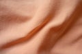 Folded apricot-colored simple cotton jersey fabric