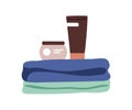 Folded bath towels stack, cream tube, cosmetics jar. Cosmetic products items, hygiene stuff. Abstract bathroom