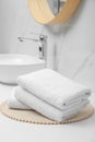 Folded bath towels on white table in bathroom Royalty Free Stock Photo