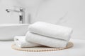 Folded bath towels on white table in bathroom Royalty Free Stock Photo