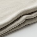 Folded beige fabric with a textured surface. The material appears soft and layered, Royalty Free Stock Photo