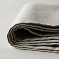 Folded beige linen fabric placed on Royalty Free Stock Photo