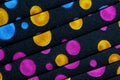 Folded fabric with red, blue, pink, gold and green dots / circles