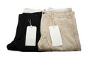 Folded Black and Khaki Trousers with tagging