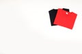 Folded black and red t-shirts isolated on white background Royalty Free Stock Photo