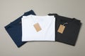 Folded blank t-shirts with tags on gray background Royalty Free Stock Photo