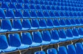 Folded blue plastic chairs on a temporary tribune.