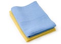 Folded blue and yellow waffle towels on a white background