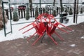 Folded cafe chairs on an outdoor terrace in winter. Snowfall on the cafe terrace Royalty Free Stock Photo