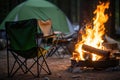 folded camp chairs next to a roaring campfire