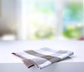 Folded kitchen checkered towel on table. Royalty Free Stock Photo