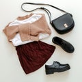 Folded clothes for women fashion urban basic outfit. Female spring look autumn outfit burgundy skirt beige sweater black