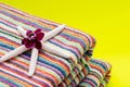 Folded Colorful Striped Organic Cotton Beach Towels decorated with White Finger Starfish and Orchid Flower on bright yellow Royalty Free Stock Photo