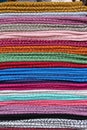 Folded colourful scarves woven from alpaca wool for sale at Otavalo market, Ecuador Royalty Free Stock Photo