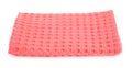 Folded coral kitchen towel on white