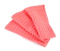 Folded coral kitchen towel on white