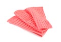 Folded coral kitchen towel on white