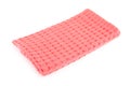 Folded coral kitchen towel on white