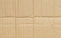 Folded corrugated cardboard surface texture background. Seamless crumpled brown paper textured backdrop