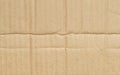 Folded corrugated cardboard surface texture background. Seamless crumpled brown paper textured backdrop Royalty Free Stock Photo