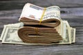 Folded Egyptian money 200 LE and pile of American money  on wood, two hundred Egyptian pounds cash money bills folded up Royalty Free Stock Photo