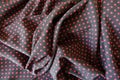 Folded fabric with polka dots in black and red