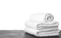 Folded fresh clean towels for bathroom on table against background. Space for text Royalty Free Stock Photo