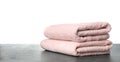 Folded fresh clean towels for bathroom on table against background. Space for text Royalty Free Stock Photo