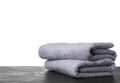 Folded fresh clean towels for bathroom on table against background. Space for text Royalty Free Stock Photo