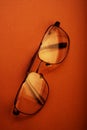 Folded glasses lie on a brown background Royalty Free Stock Photo