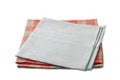 Folded gray and red-checkered textile napkins stacked on white Royalty Free Stock Photo