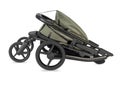 Folded Green Stroller with Black Frame and Wheels Royalty Free Stock Photo