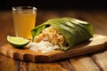 folded grilled taco with dripping lime juice on a bamboo board