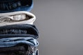 Folded jeans on gray background with place for text. Close-up Royalty Free Stock Photo